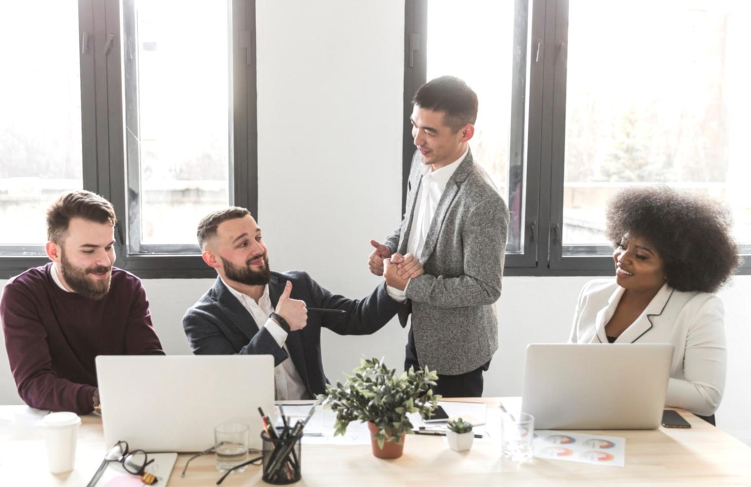 Students reviewing video editing project on computer screen during collaborative learning session